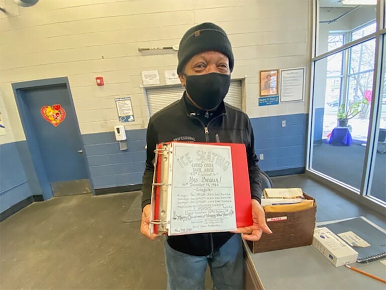 Jimi Lewis, the senior skating instructor at Laura Sims Skate House, holds a flyer from 1986 that he created. (Taylor Allen/WHYY)