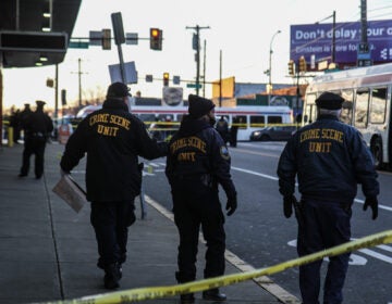 Members of the Philadelphia Police Department’s Crime Scene Unit are pictured behind crime scene tape