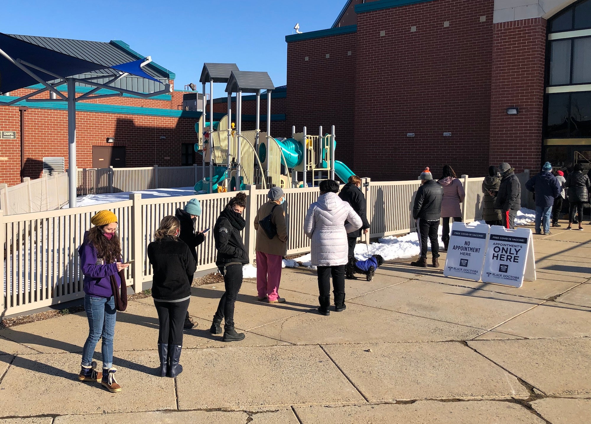 People wait in line to receive the COVID-19 vaccine in Philadelphia.