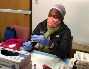 Dr. Ala Stanford sits at a table during a vaccine clinic