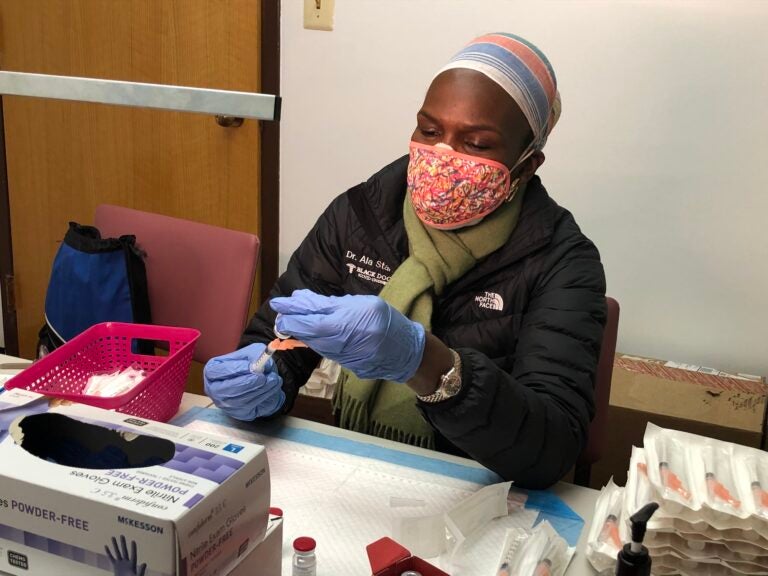 Dr. Ala Stanford sits at a table during a vaccine clinic