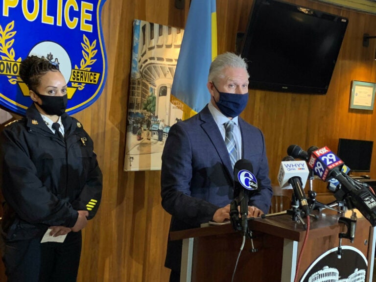 Homicide Capt. Jason Smith, standing next to Commissioner Outlaw, addresses the media at a press conference