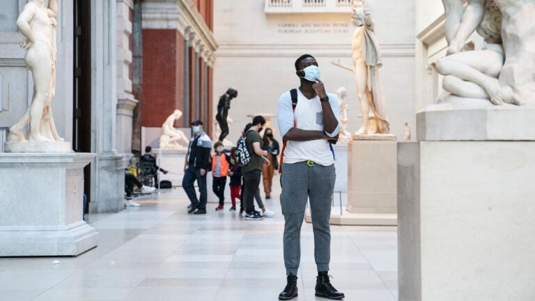 Visitors wear masks at the Metropolitan Museum of Art in October. (John Minchillo/AP)