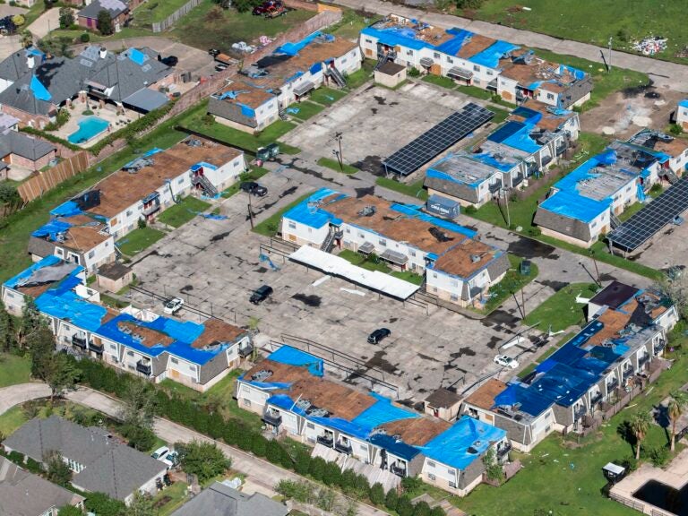 Blue tarps cover houses with damaged roofs in Lake Charles, La., after Hurricane Delta hit the city in October 2020. (Bill Feig/AP)