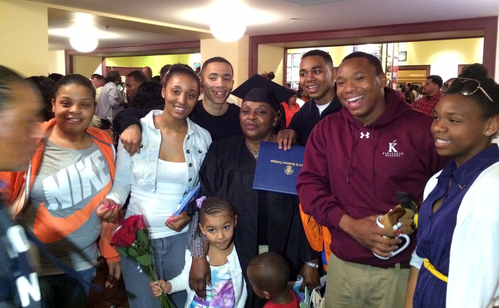 Diane Butler surrounded by grandchildren and great-grandchildren at her graduation ceremony from Bryant & Stratton College, 2013