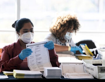 Election workers count Fulton County ballots at State Farm Arena on Nov. 4, 2020 in Atlanta. Falsehoods spread by former President Trump and his allies led to threats against election workers. (Jessica McGowan/Getty Images)