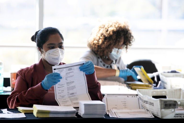 Election workers count Fulton County ballots at State Farm Arena on Nov. 4, 2020 in Atlanta. Falsehoods spread by former President Trump and his allies led to threats against election workers. (Jessica McGowan/Getty Images)