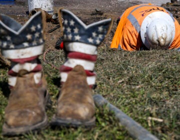 A worker fixes a water pipe in Galveston, Texas, on Feb. 19. The power is back on in much of the state, but the Lone Star State now faces the hefty cost of emerging from its devastating storms.