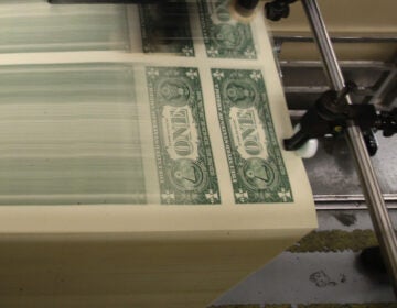 Sheets of one-dollar bills run through the printing press at the Bureau of Engraving and Printing in 2015 in Washington, D.C. Congressional forecasters projected the federal deficit this fiscal year will hit its highest since World War II. (Mark Wilson/Getty Images)