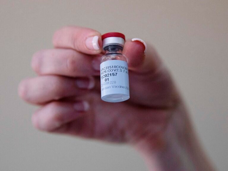 A health care worker holds a vial of the Johnson & Johnson COVID-19 vaccine at Klerksdorp Hospital in Klerksdorp, South Africa, on Feb. 18. (Phill Magakoe/AFP via Getty Images)