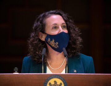 Pennsylvania Secretary Kathy Boockvar, wearing a face mask, addresses the media from behind a podium