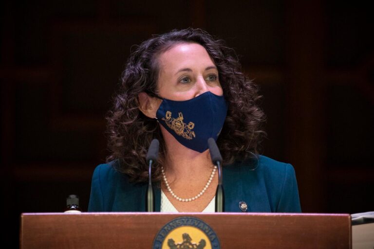 Pennsylvania Secretary Kathy Boockvar, wearing a face mask, addresses the media from behind a podium