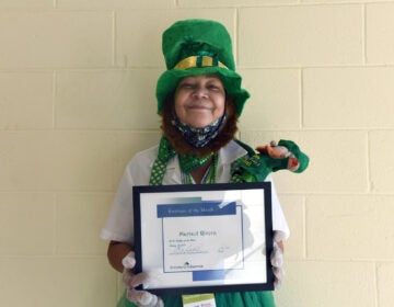 On January 27 at the COVID-19 vaccination center at Camden County College in Blackwood, NJ, Marisol Rivera shows off the Prichard Industries Employee of the Month certificate she's just been awarded. (April Saul for WHYY)