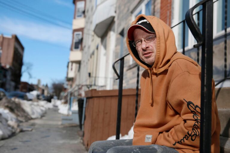 Michael Salemno sits on a stoop outside