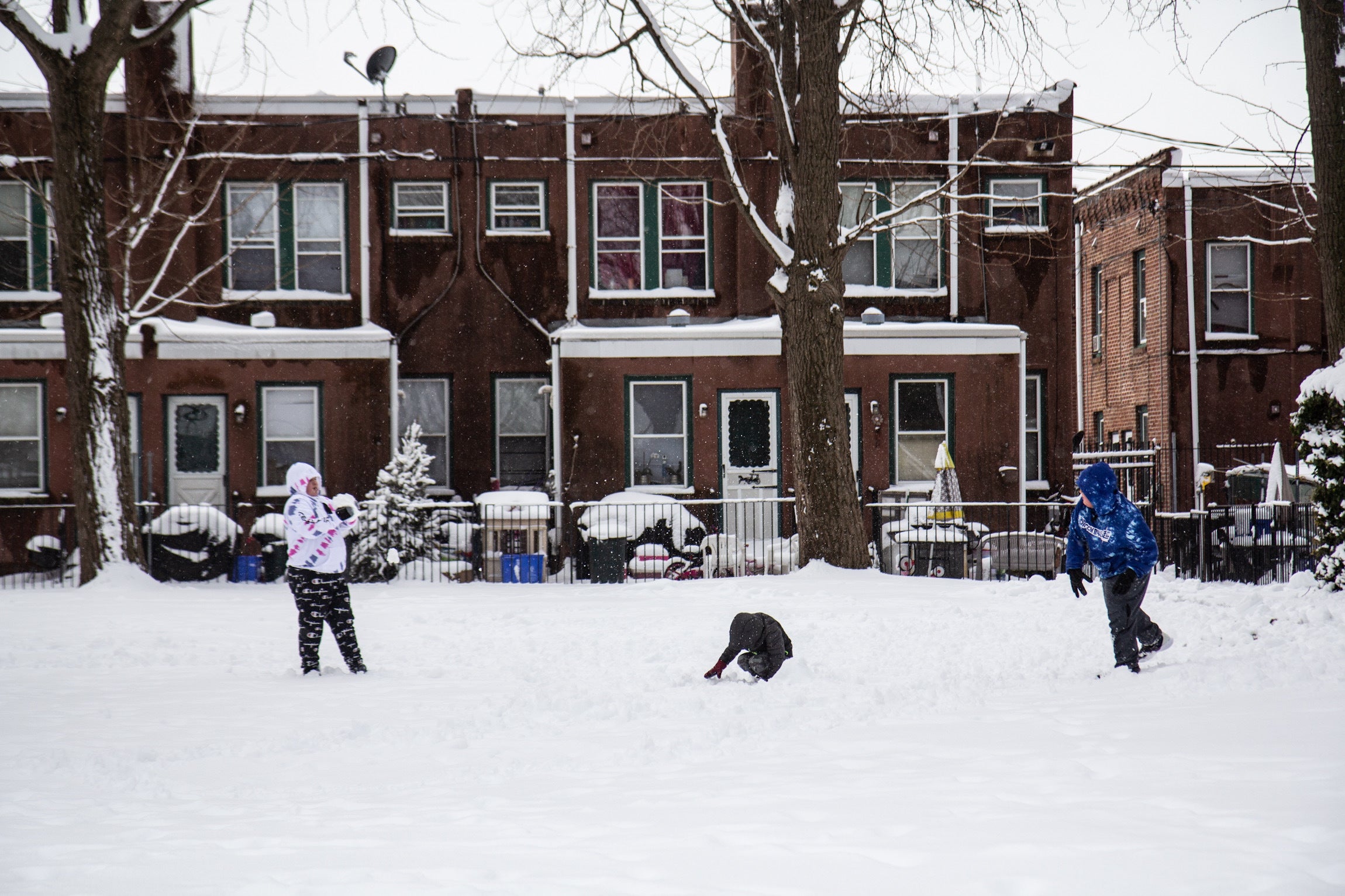 Kids toss snowballs around a courtyard in Philadelphia.