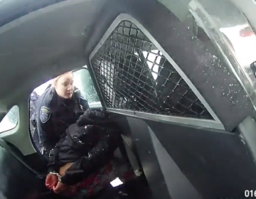 A frame from a Rochester Police bodycam video showing a girl in handcuffs in the back of a police cruiser.
(Rochester Police-YouTube/Screenshot by NPR)