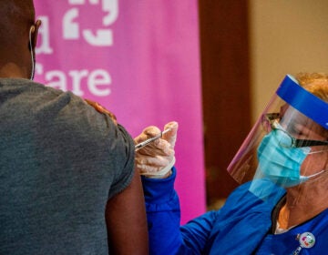 Nurse Keith Grant got his second dose of Pfizer's COVID-19 vaccine on schedule from registered nurse Valerie Massaro in January at the Hartford Convention Center — 21 days after his first immunization.