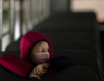 A first-grade student sits on the bus after a day of classes in Woodland, Wash., on Thursday.