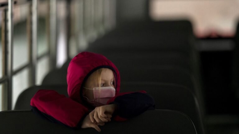 A first-grade student sits on the bus after a day of classes in Woodland, Wash., on Thursday.