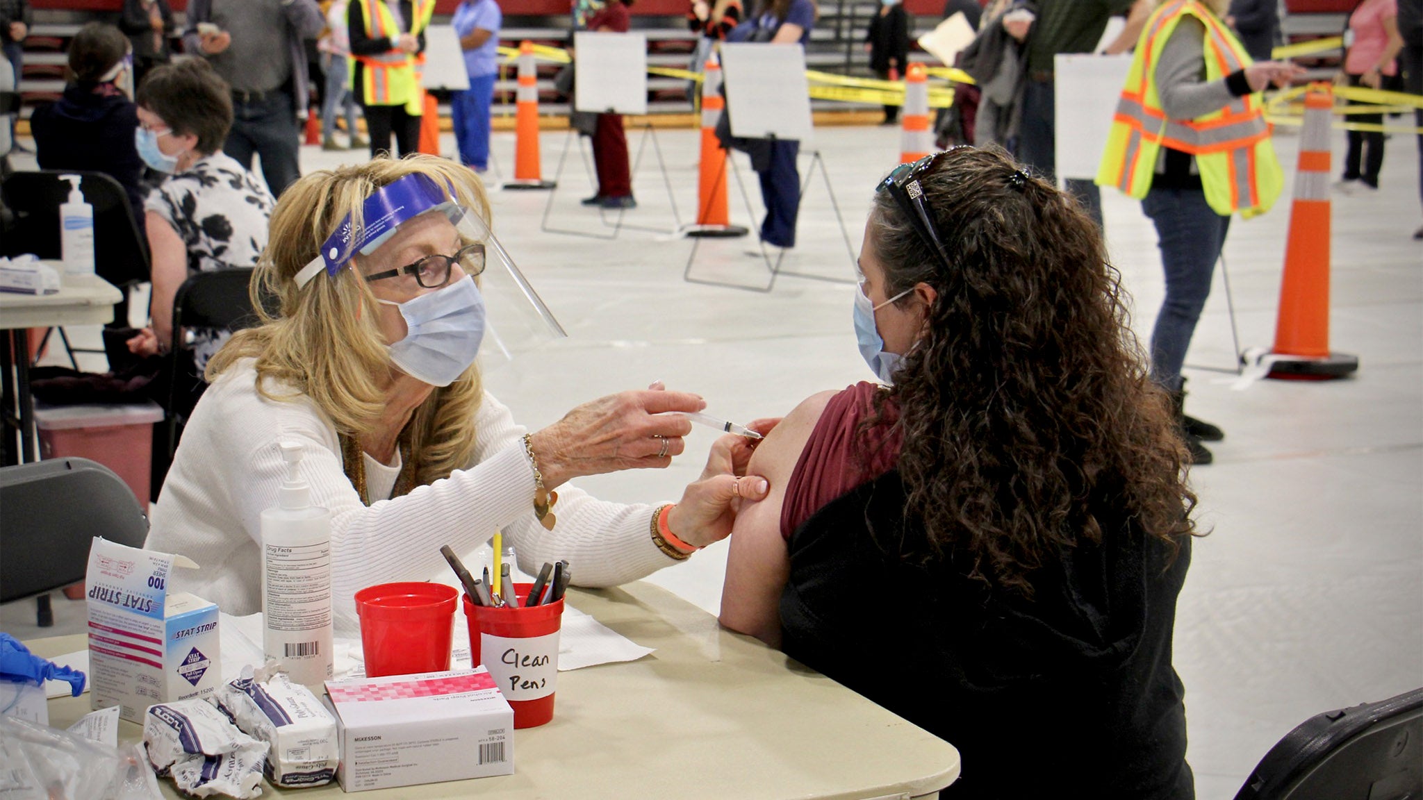 Registered nurse Pat DeHorsey vaccinates physician assistant Dana Steinter