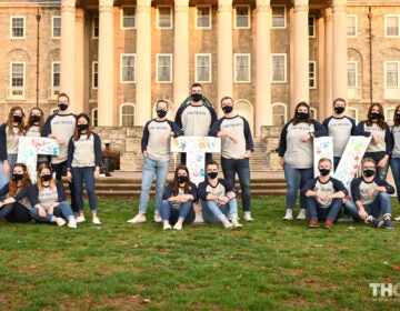 Penn State THON executive leaders sit on campus wearing face masks