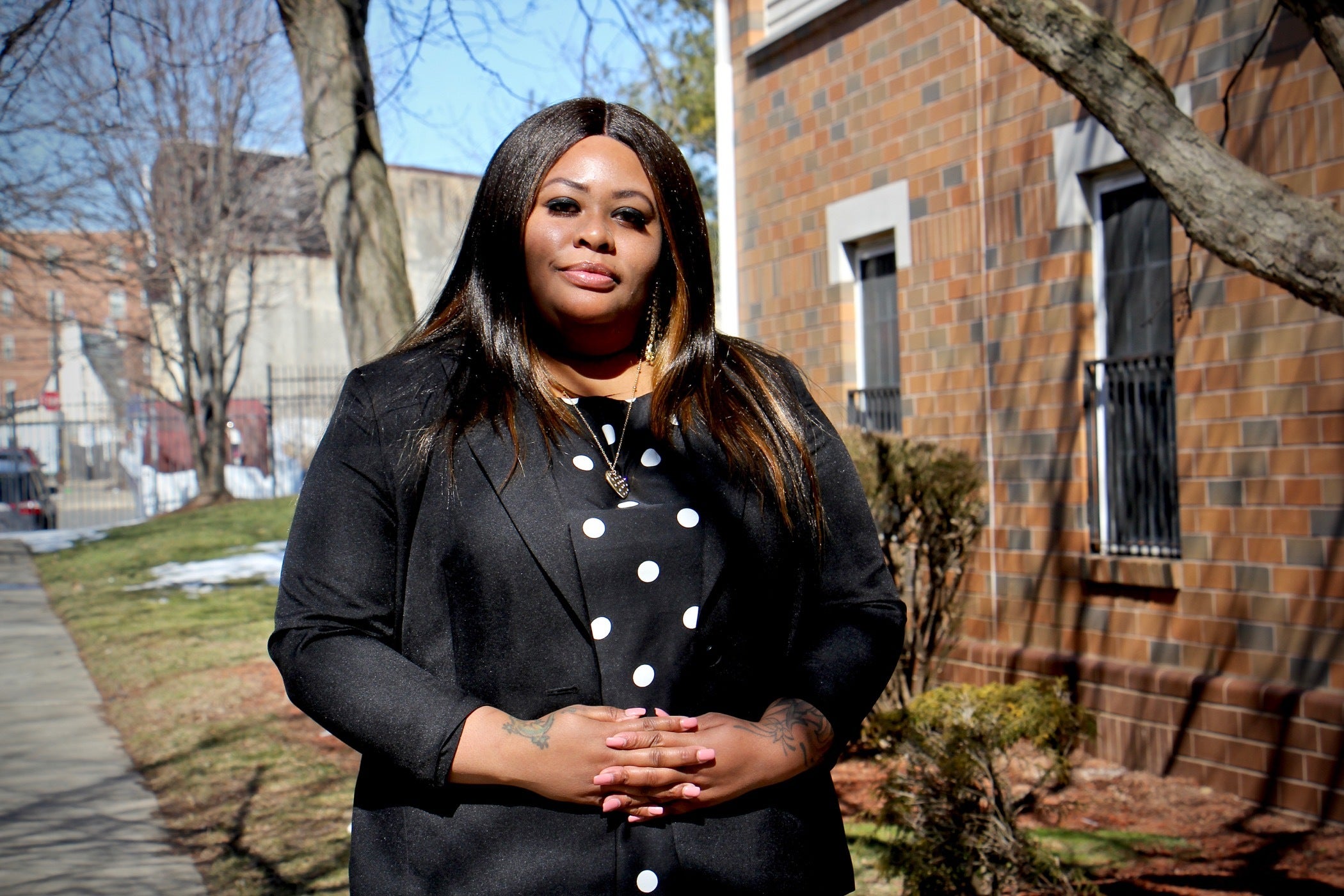 Tawandaa Austin stands on a sidewalk