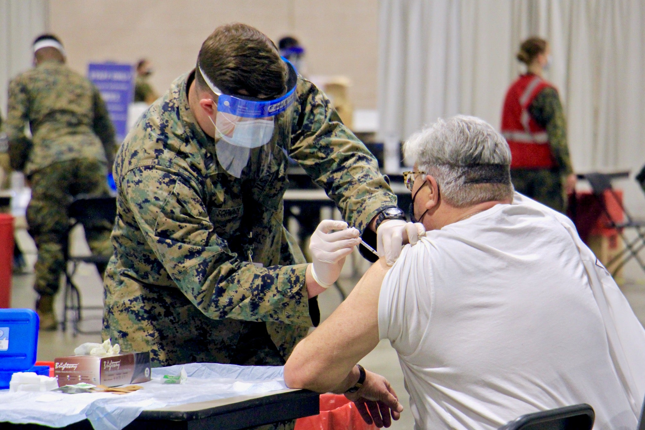 A National Guard member vaccinates someone against COVID-19 at the Pennsylvania Convention Center