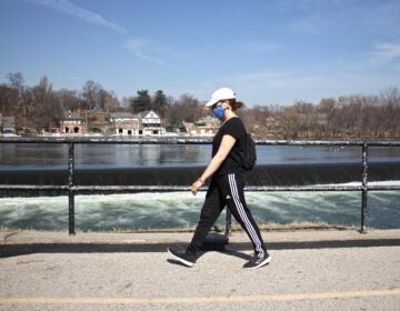 Maria Becker Gallagher strolls past the Schuylkill River on Martin Luther King Drive on March 11, 2021. (Emma Lee/WHYY)