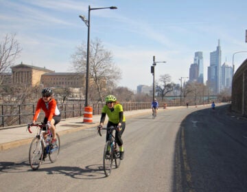 Cyclists and joggers use Martin Luther King Drive on March 11, 2021, which has been closed to traffic since the start of the pandemic. (Emma Lee/WHYY)