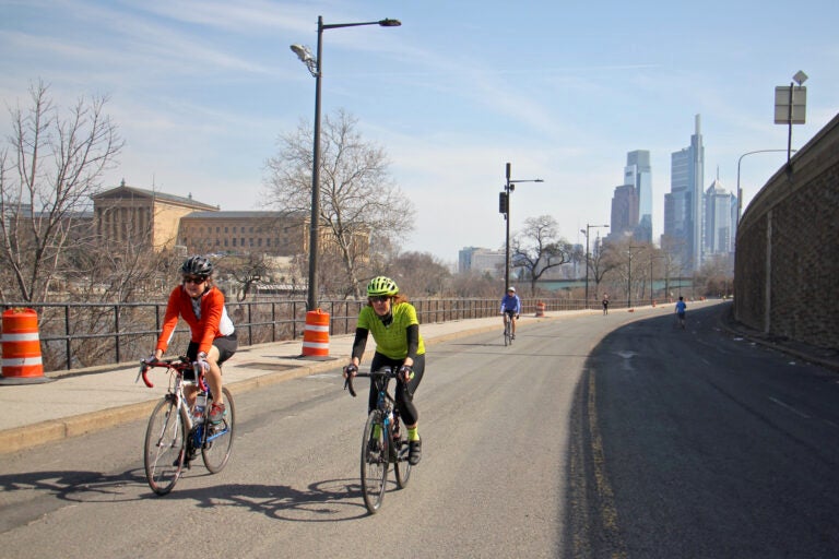 Cyclists and joggers use Martin Luther King Drive on March 11, 2021, which has been closed to traffic since the start of the pandemic. (Emma Lee/WHYY)