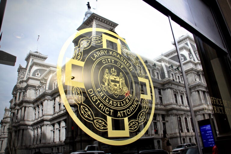 Philadelphia City Hall is reflected in the windows of the Office of the District Attorney