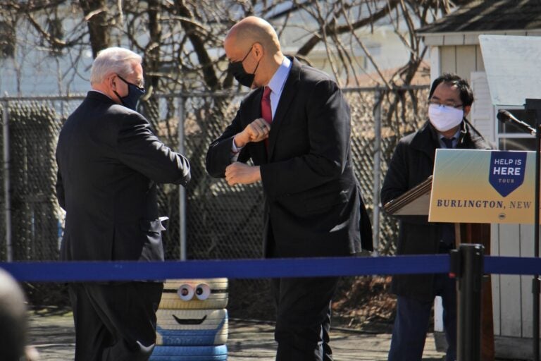 New Jersey U.S. Sens. Robert Menendez (left) and Cory Booker bump elbows while U.S. Rep. Andy Kim looks on