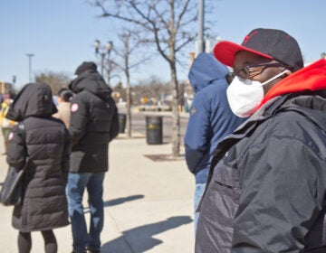 N.J. Transit worker Antonio Harriot waits in line to get the COVID-19 vaccine