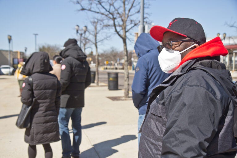 N.J. Transit worker Antonio Harriot waits in line to get the COVID-19 vaccine