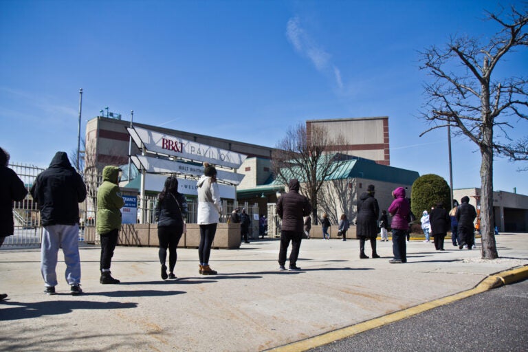 People line up for the COVID-19 vaccine outside the BB&T Pavilion in Camden