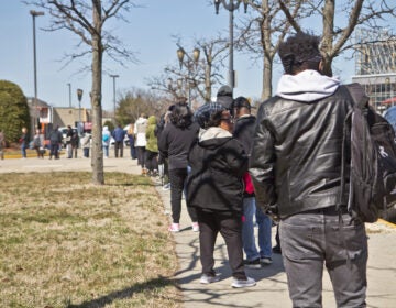 People line up for the COVID-19 vaccine outside the BB&T Pavilion in Camden