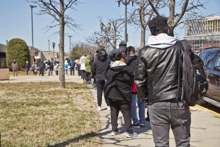 People line up for the COVID-19 vaccine outside the BB&T Pavilion in Camden