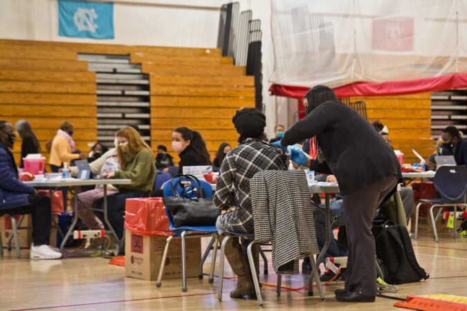 A resident of Philadelphia’s Nicetown neighborhood receives the COVID-19 vaccine