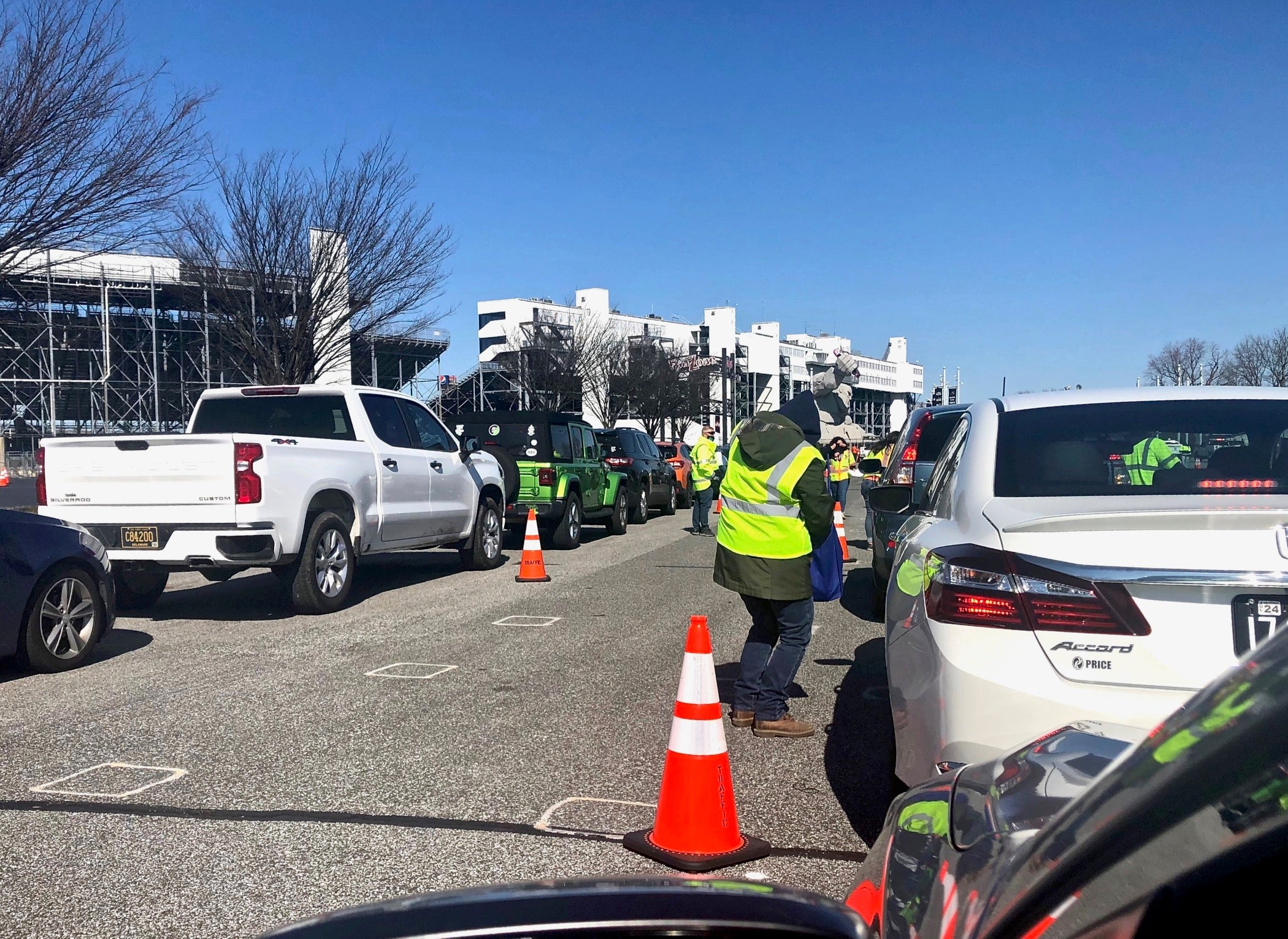 Drivers wait in line to receive COVID-19 vaccinations