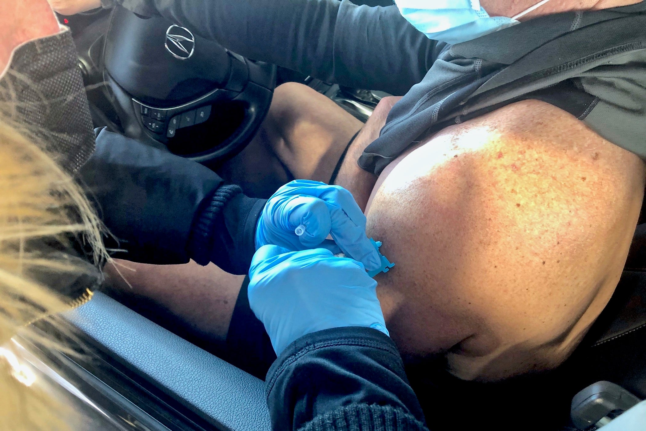 Cris Barrish gets his first injection of the Pfizer vaccine at Dover International Speedway