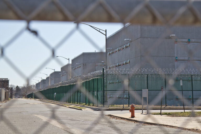The exterior of Curran-Fromhold Correctional Facility as seen through a fence