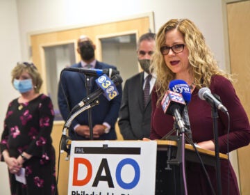 Kimberly Esack addresses the press from a DAO podium
