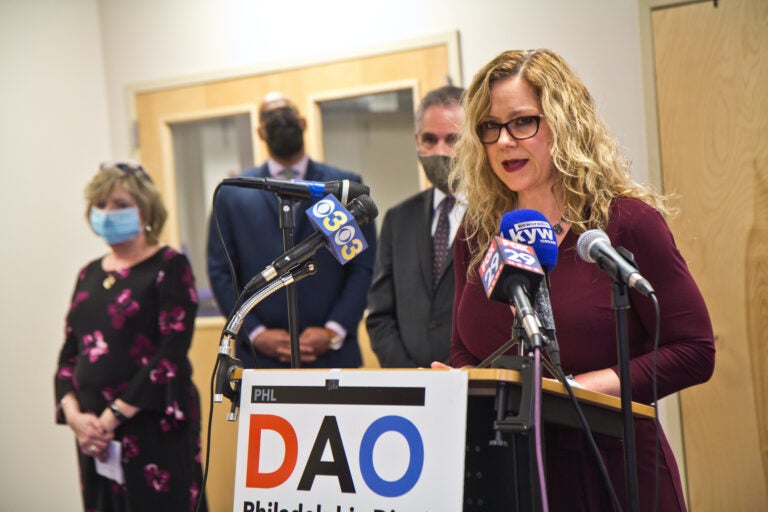 Kimberly Esack addresses the press from a DAO podium