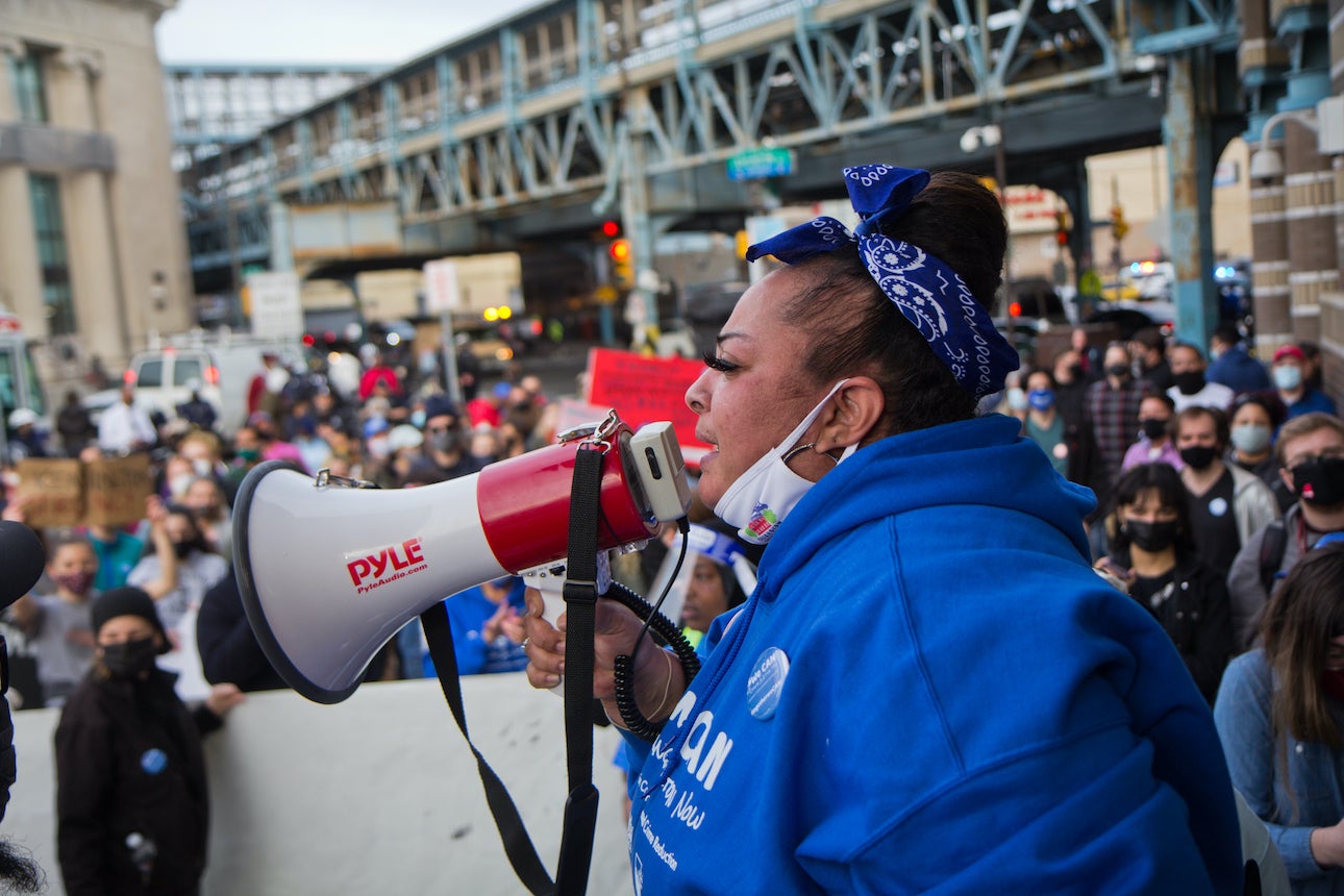 Gloria “Smoochie” Cartagena speaks frmo a megaphone at a protest over Somerset Station's closure