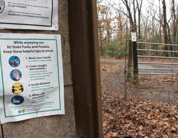 A flyer detailing COVID-19 precautions persists at Rancocas State Park in Burlington County, N.J. (Emma Lee/WHYY)