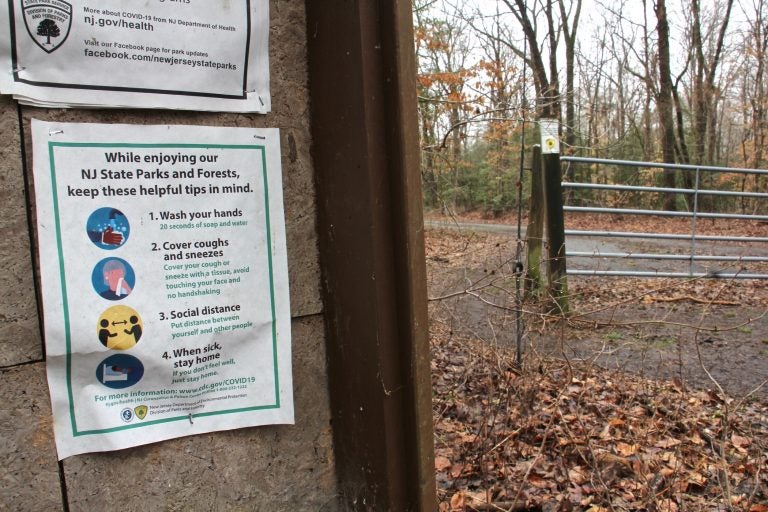 A flyer detailing COVID-19 precautions persists at Rancocas State Park in Burlington County, N.J. (Emma Lee/WHYY)