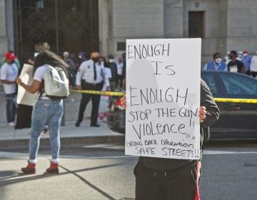 Activists hung caution tape around City Hall in Philadelphia on March 26, 2021, to bring the crime scenes they witness in their neighborhoods to city officials’ work place. (Kimberly Paynter/WHYY)