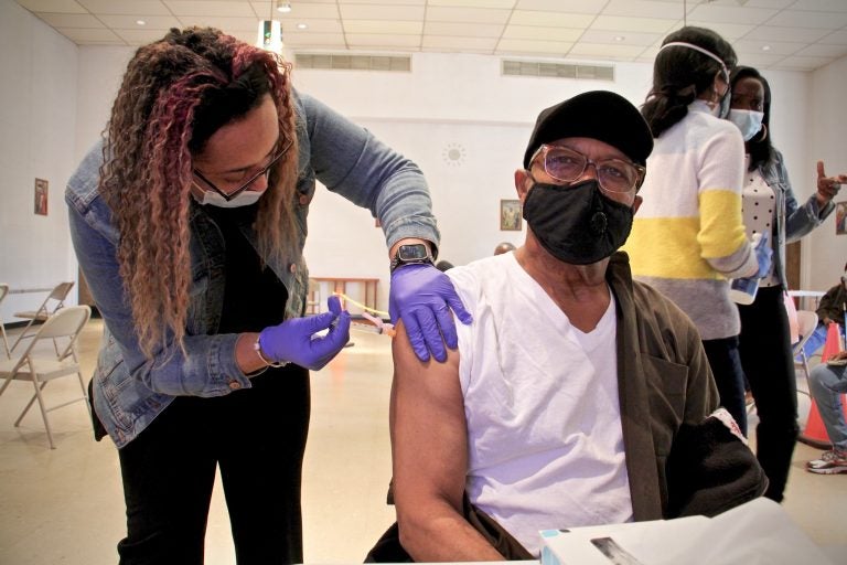 Thomas W. Munson receives his second dose of COVID-19 vaccine from registered nurse Elizabeth Lash