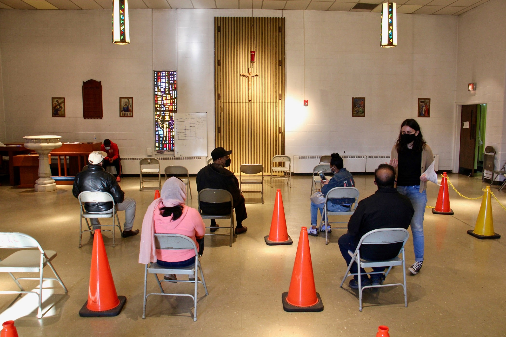 Patients wait to be vaccinated against COVID-19 at the Sayre Health clinic