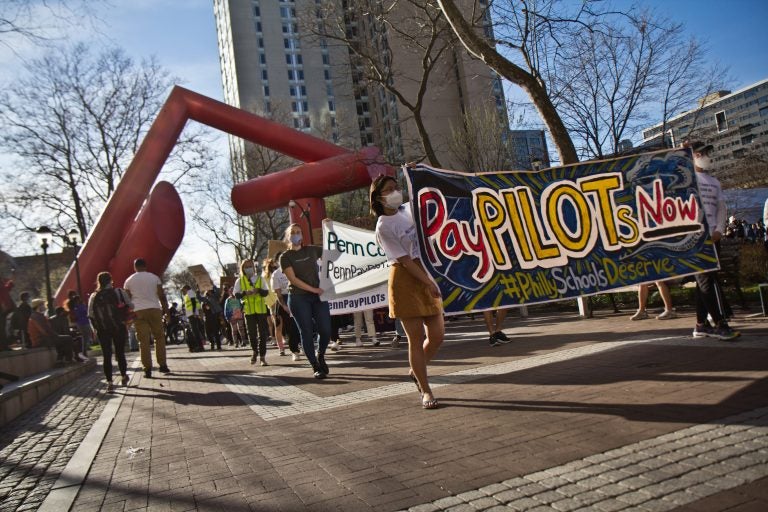 Protesters march on the campus of the University of Pennsylvania demanding the school and Drexel University pay PILOTS to support Philadelphia schools on March 30, 2021. (Kimberly Paynter/WHYY)